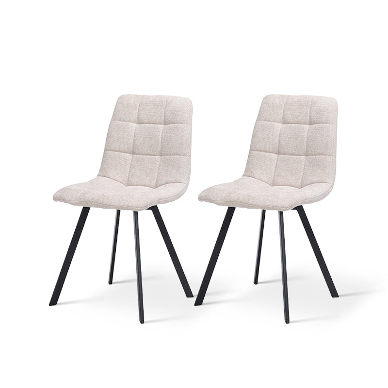 Set of four Aoife upholstered dining chairs around a contemporary table in a stylish dining room setting Space saving dining chair product shot | Cheap dining chairs set of 2 option