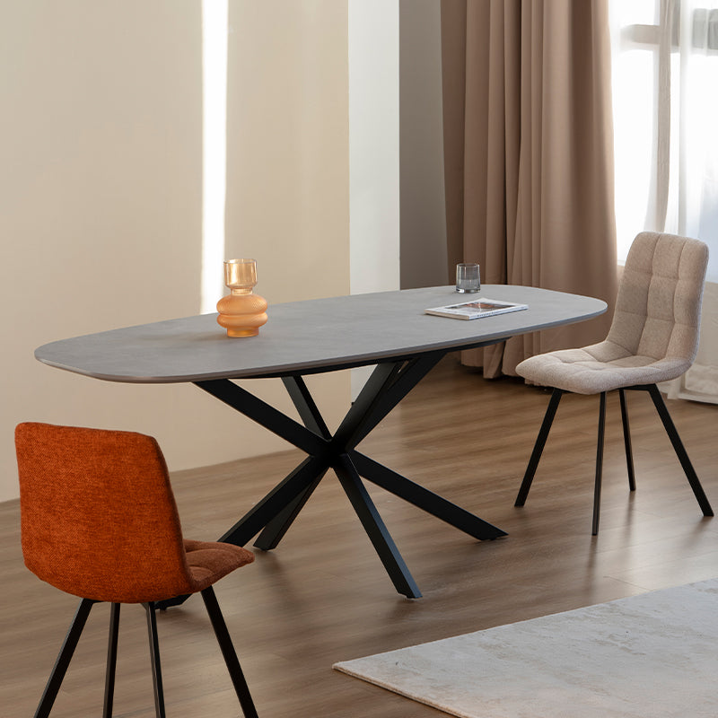 Discover the OFCASA Geena Ellipse Dining Table in grey marble melamine with black crossed metal legs. 180 cm seats six, durable & easy clean—ideal for modern UK dining.Modern budget dining table in family home setting