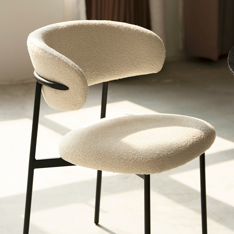 Side view showing Zahra chair's ergonomic curved back and slim tapered beechwood legs