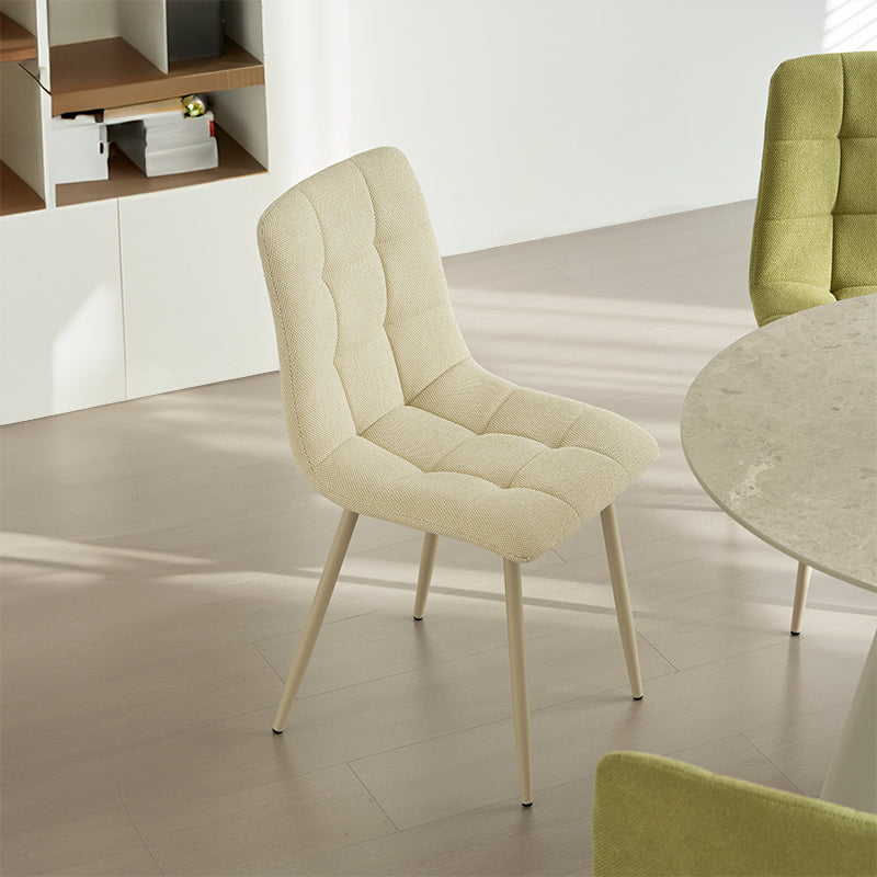 Experience comfort and style with Aoife Dining Chairs: linen blend upholstery, diamond grid stitching and slender metal legs for modern elegance.