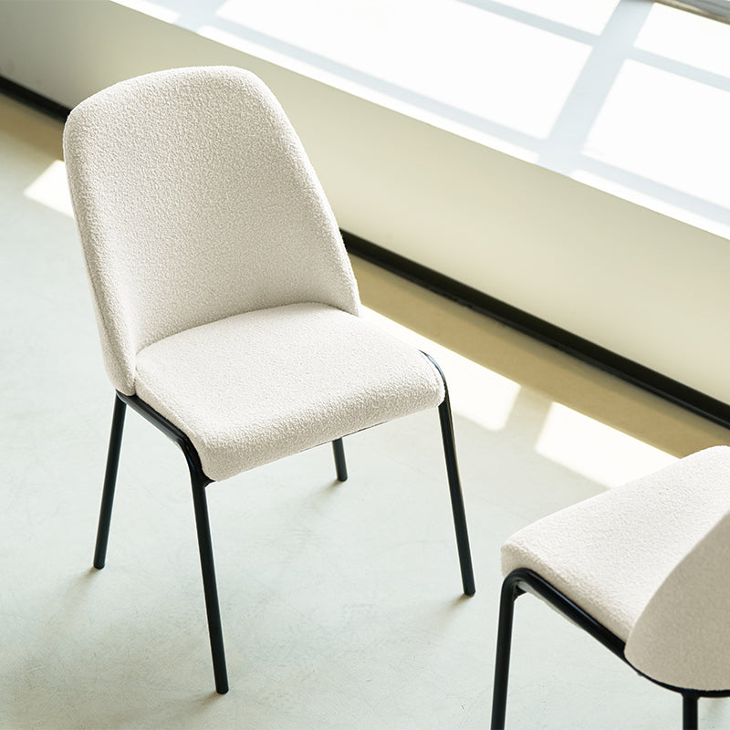 Upgrade your dining or workspace with the Danica Boucle Dining Chairs from OFCASA. Soft, sculptural seats on slender black legs bring Scandinavian style and lasting comfort to any room.
