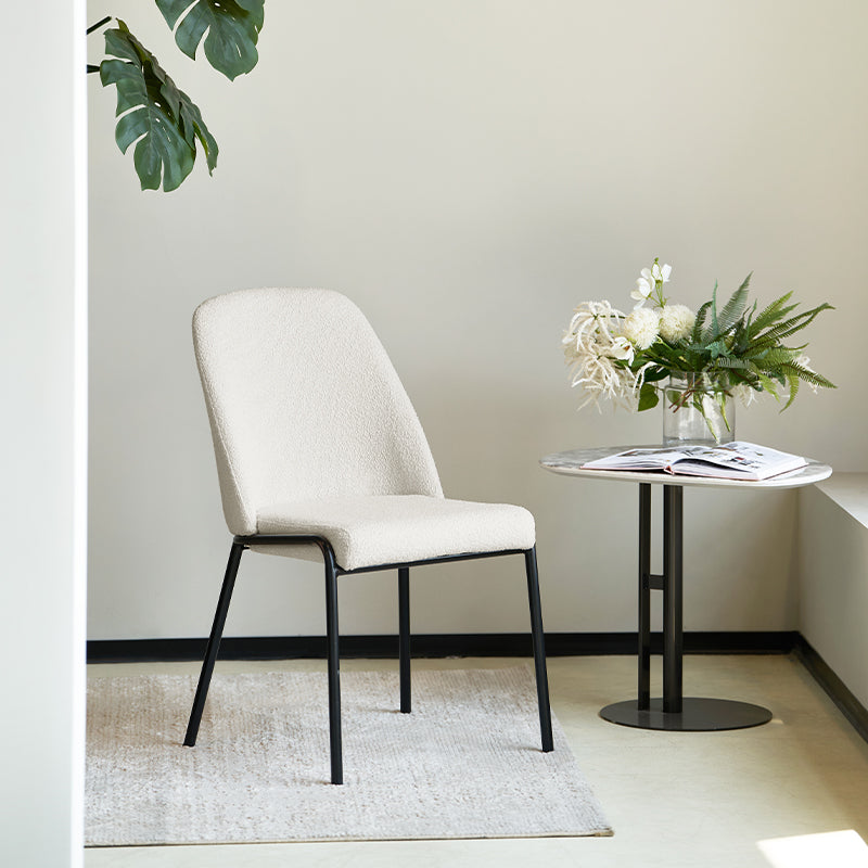 Upgrade your dining or workspace with the Danica Boucle Dining Chairs from OFCASA. Soft, sculptural seats on slender black legs bring Scandinavian style and lasting comfort to any room.