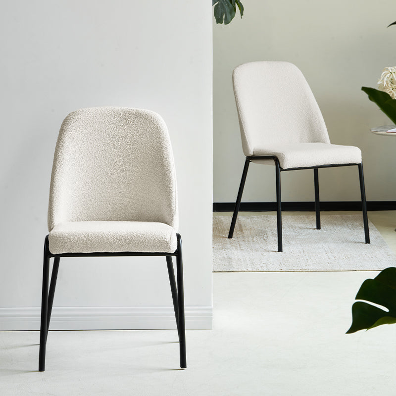 Upgrade your dining or workspace with the Danica Boucle Dining Chairs from OFCASA. Soft, sculptural seats on slender black legs bring Scandinavian style and lasting comfort to any room.