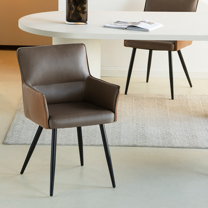 Elevate dining with Kaya’s PU leather armchairs featuring two tone patchwork upholstery, foam padded seat, and black steel legs for a modern, durable finish.