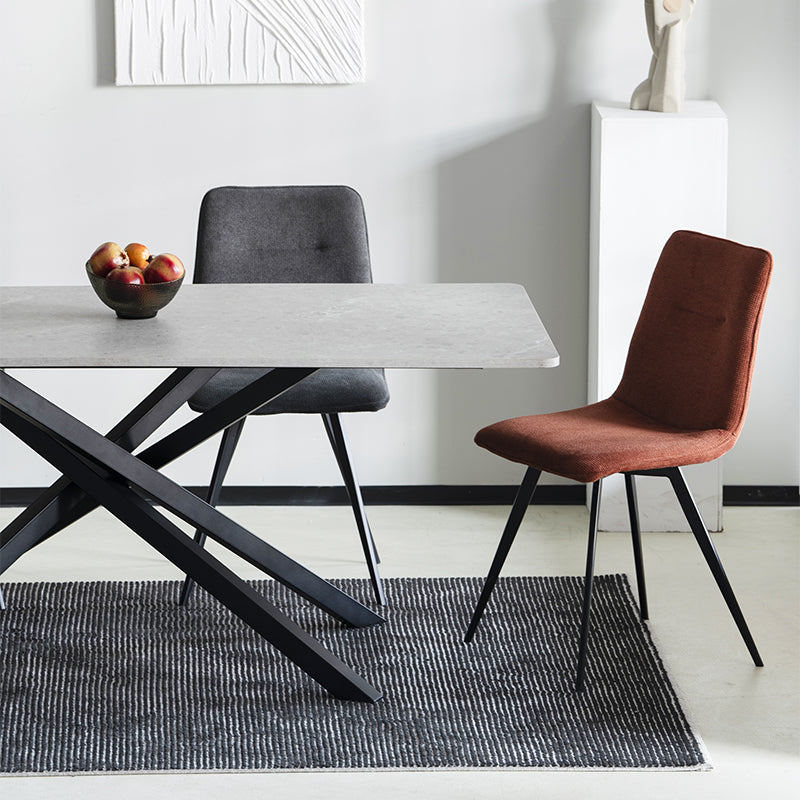 Elevate dinner parties with the Thalia Rectangular Dining Table from OFCASA. Its grey marble patterned tabletop and sculptural black metal legs create a statement of modern luxury.
