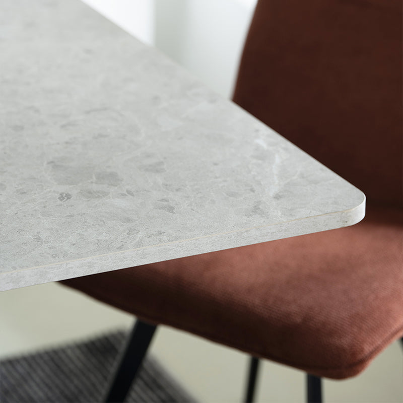 Elevate dinner parties with the Thalia Rectangular Dining Table from OFCASA. Its grey marble patterned tabletop and sculptural black metal legs create a statement of modern luxury.