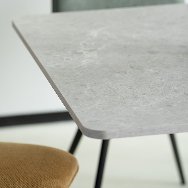 Elevate dinner parties with the Thalia Rectangular Dining Table from OFCASA. Its grey marble patterned tabletop and sculptural black metal legs create a statement of modern luxury.