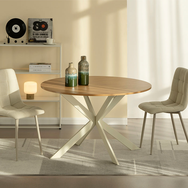 Discover the OFCASA Tilly Round Dining Table. 120 cm wood-effect melamine top, sturdy metal X-legs, and easy assembly—perfect for table and 4 dining chairs in modern UK homes. Modern budget dining table in family home setting. Cheap dining table.