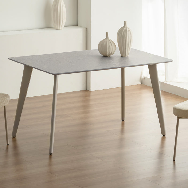 Discover the OFCASA Valdez Dining Table: 140 cm grey marble–effect top, sturdy black metal legs, and easy assembly. Perfect for modern UK dining spaces. Modern budget dining table in family home setting