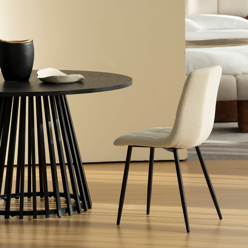 Experience comfort and style with Aoife Dining Chairs: linen blend upholstery, diamond grid stitching and slender metal legs for modern elegance.
