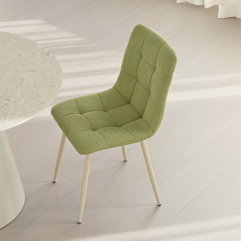 Experience comfort and style with Aoife Dining Chairs: linen blend upholstery, diamond grid stitching and slender metal legs for modern elegance.
