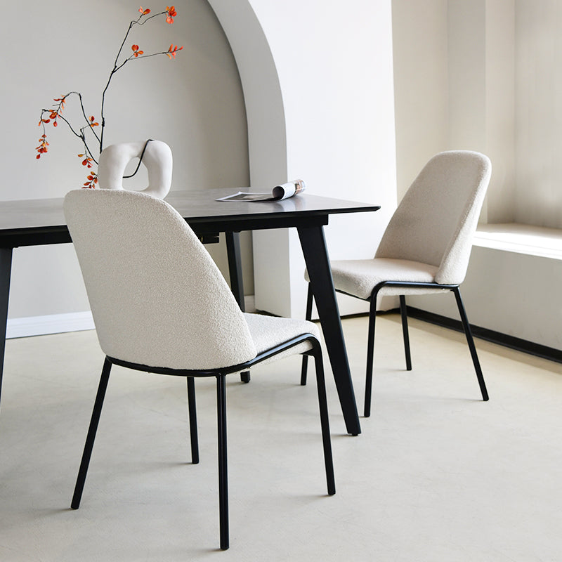Upgrade your dining or workspace with the Danica Boucle Dining Chairs from OFCASA. Soft, sculptural seats on slender black legs bring Scandinavian style and lasting comfort to any room.
