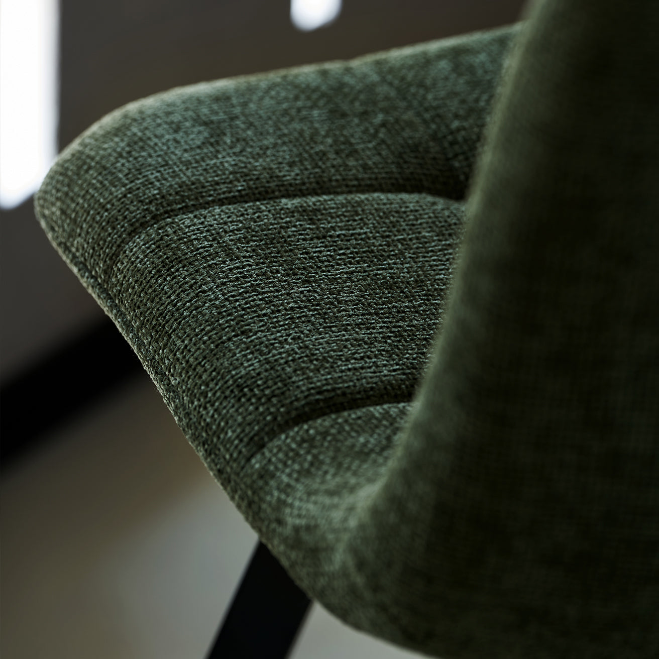 Black powder-coated metal legs on Aoife dining chairs providing stable support with scratch-resistant floor protectors